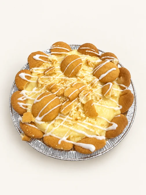 Banana pudding pie topped with vanilla wafers and a white icing drizzle